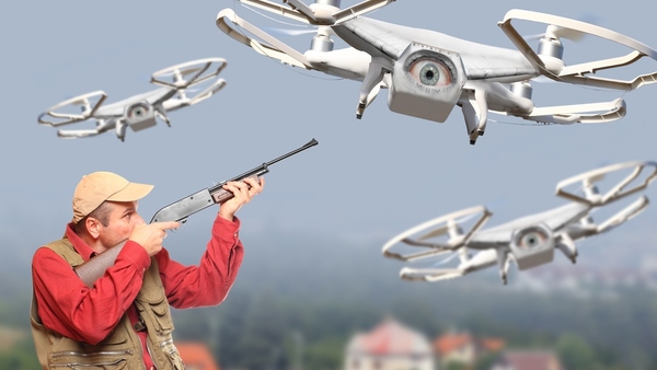 man-with-shotgun-shooting-down-drone-crop-shutters-crop-600x338.jpg